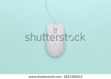 Modern White Wired Computer Mouse on Minimalist Pastel Background
