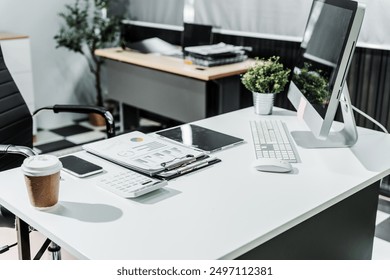 A modern, white-colored business office with a wooden desk, calculator, desktop computer, and a black leather chair. The executive office features private office furniture for the chief of staff.