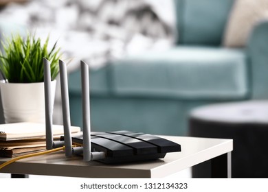 Modern wi-fi router on light table in room - Shutterstock ID 1312134323