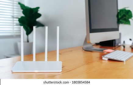 Modern WiFi Router On Light Table In Home Office