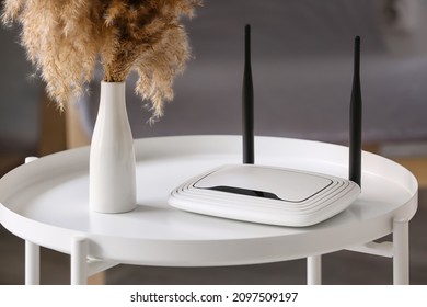 Modern Wi-fi Router On Table In Room