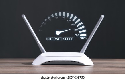 Modern wifi router with a speedometer. Internet speed - Shutterstock ID 2054039753