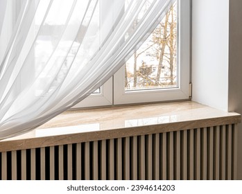 Modern window sill made of marble stone. Close-up shot