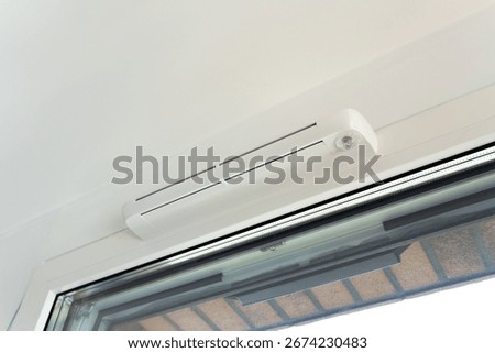 Modern window vent for efficient air supply and comfort. Close-up of trickle vent integrated into a window. Concept of home ventilation, energy-saving design, and climate control technology.