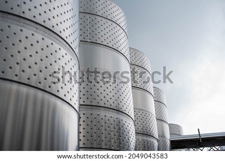 modern winery. Steel wine tanks for wine fermentation at a winery. modern wine factory with large shine tanks for the fermentation.