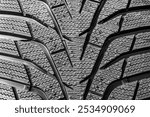 Modern winter tire tread closeup that has passed the braking test on ice and marked with a new pictogram of an icy mountain peak