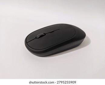 Modern wireless computer mouse placed on a white surface with copy space. Suitable for office and technology themes.