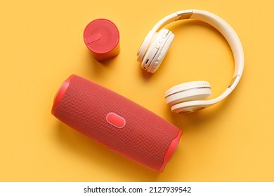 Modern wireless portable speakers and headphones on color background - Shutterstock ID 2127939542