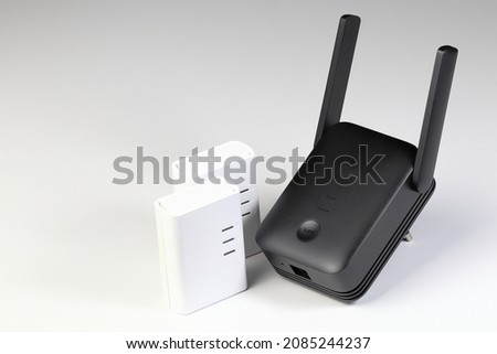 Modern Wireless Router,  Network Router, WiFi Repeater,  WiFi Amplifier or wifi range extender and The couple of powerline network adaptors  isolated on white background.