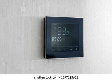 Modern Wireless Thermostat Installed On The White Wall At Home. Smart Home Heating Regulation Concept