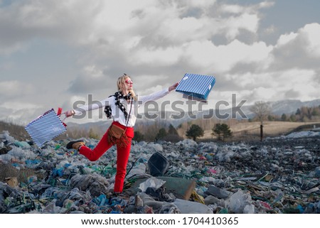Modern woman on landfill, consumerism versus pollution concept.