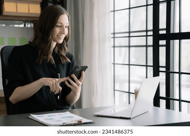 Modern woman typing and messagin with mobile phone. Women using cellphone app. Technology and computer workplace.