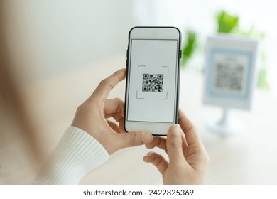 Modern woman use phone to scan barcode or QR codes to pay credit card bill after receive document invoice. payment, receive, paying electricity, digital payments without money, technology, scanning - Powered by Shutterstock