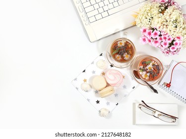 Modern Woman's Desktop, Home Office. Computer, A Cup Of Herbal Chamomile Tea And Spring Flowers On A Pastel Table. Minimal Business Concept, Hello Summer, Home Comfort, Top View, Flat Lay, 