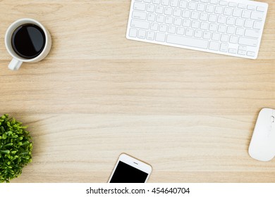 Modern Wood Office Desk Table With Computer Keyboard, Mouse, Coffee Cup And Smartphone. Top View With Copy Space, Flat Lay.