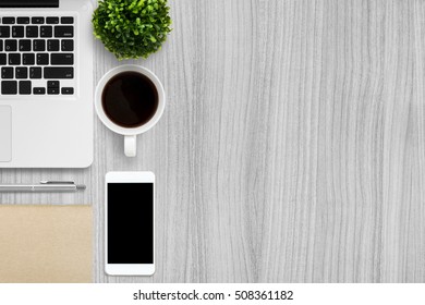 Modern Wood Office Desk Table With Laptop, Smartphone, Cup Of Coffee And Supplies. Top View With Copy Space, Flat Lay.