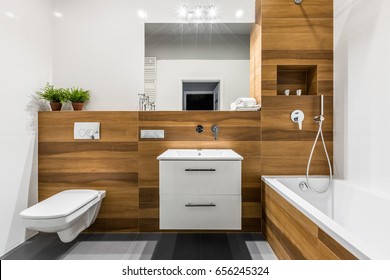 Modern, Wooden Bathroom With Bathtub, Mirror, Toilet, Cabinet And Sink