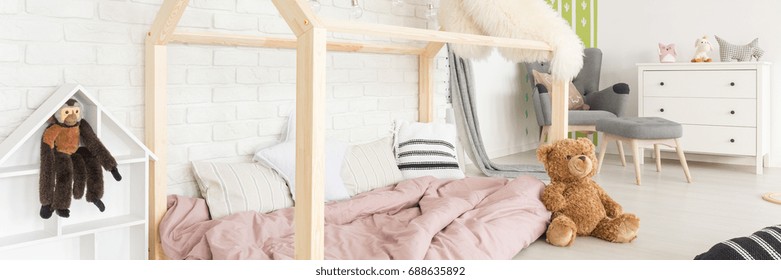 Modern wooden bed in house shape in cozy baby room - Powered by Shutterstock