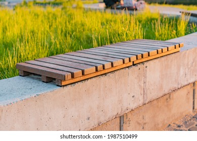 Modern Wooden Concrete Bench In The Park. Small Timber. Minimalism. Wooden Slats. Concrete Block. Outdoor. Urban. City. Nature