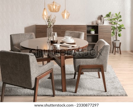 a modern wooden dining set in a stylishly designed room featuring hardwood floors and contemporary furniture