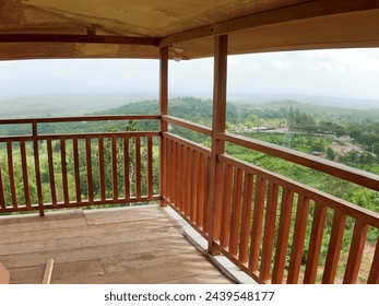 Modern wooden eco friendly house villa luxury mansion facade. The wooden hut is located on a high hill, with paved paths and a wide ocean as a backdrop - Powered by Shutterstock