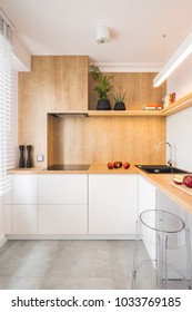 Modern, Wooden Kitchen With White Furniture And Transparent Chair