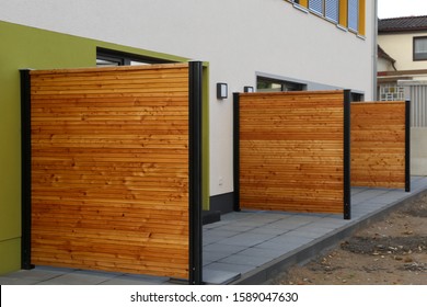 Modern wooden privacy fences on a residential complex