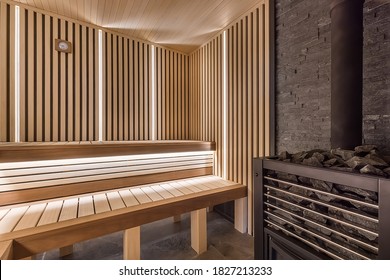 Modern wooden sauna interior with elegant lighting and electric heater