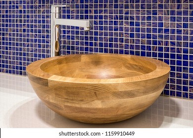 Modern Wooden Sink With Mosaic Tiles In The Background.