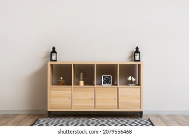 Modern Wooden TV Stand With Decor Near Light Wall