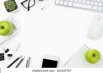 Modern working table with it gadgets and office supplies. Top view with copy space in the middle. Healthy working concept. - Powered by Shutterstock