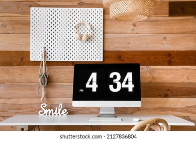 Modern Workplace With Computer And Peg Board Hanging On Wooden Wall