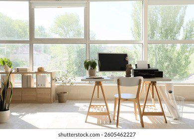 Modern workplace with computer, plant and printer in office