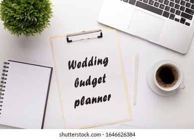 Modern Workplace With Laptop And Wedding Budget Planner On White Table