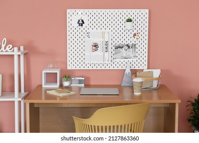 Modern Workplace With Peg Board On Pink Wall