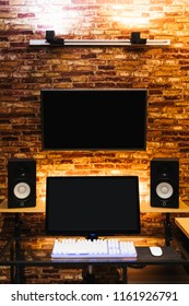 Modern Workspace With Dual Computer Monitor Display And Professional Loudspeakers In Loft Style Interior