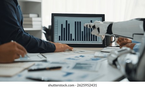 A modern workspace showcasing human collaboration with a robot in the process of data analysis, featuring a digital screen displaying statistical graphs.Noogenesis