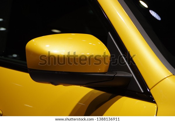 Modern yellow car rear\
view mirror detail