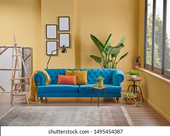 Modern Yellow Room With Blue Classic Sofa And Easel Paint Decor Interior Style.