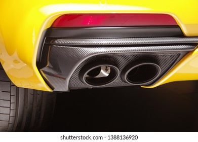 Modern yellow sports car carbon fiber exhaust pipes detail