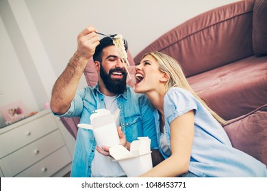 Modern Young Couple Eating And Playing With Chinese Food