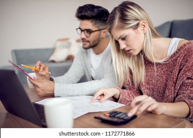 Modern Young Couple Paying Bills Online From Home.