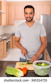 Modern Young Indian Man Cooking In Home Kitchen