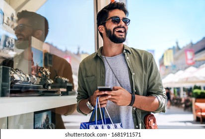 Modern Young Man Enjoying In Shopping. Consumerism, Fashion, Lifestyle Concept