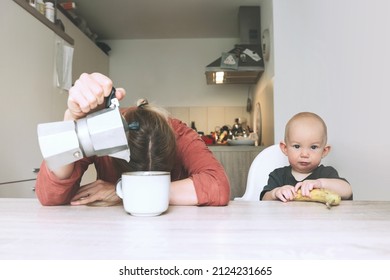 Modern Young Tired Mom And Little Child After Sleepless Night. Exhausted Woman With Baby Is Sitting With Coffee In Kitchen. Life Of Working Mother With Baby. Postpartum Depression On Maternity Leave.