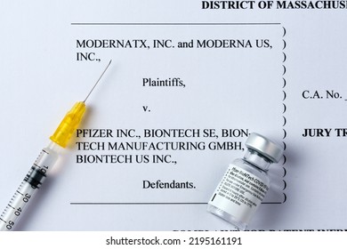 Moderna Vs Pfizer Biontech Legal Battle Concept. Real PFIZER Vaccine Vial And Syringe Placed On Printed Moderna's COMPLAINT FOR PATENT INFRINGEMENT. Stafford, United Kingdom, August 28, 2022