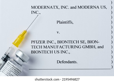 Moderna Vs Pfizer Biontech Legal Battle Concept. Real PFIZER Vaccine Vial And Syringe Placed On Printed Moderna's COMPLAINT FOR PATENT INFRINGEMENT. Stafford, UK, August 28, 2022