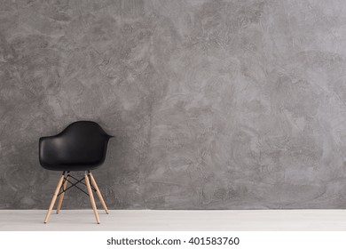 Modern,black Chair Standing In Empty Interior, Cement Wall Design In The Background