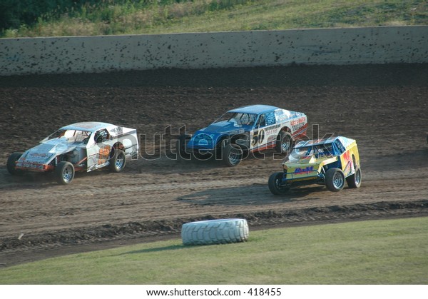 Modified cars racing on dirt\
track