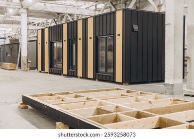 Modular building components undergoing assembly in a factory, showcasing the efficiency of prefabricated construction